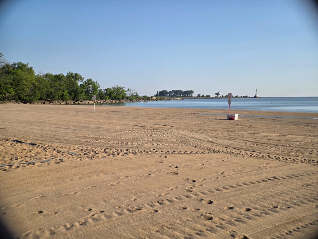 Wide sandy shoreline at Nickel Plate Beach in Huron, Ohio, featuring the Lake Erie Love sign.