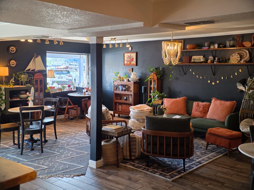Cozy quiet lounge inside The Gathering Grounds coffee shop with seating area.