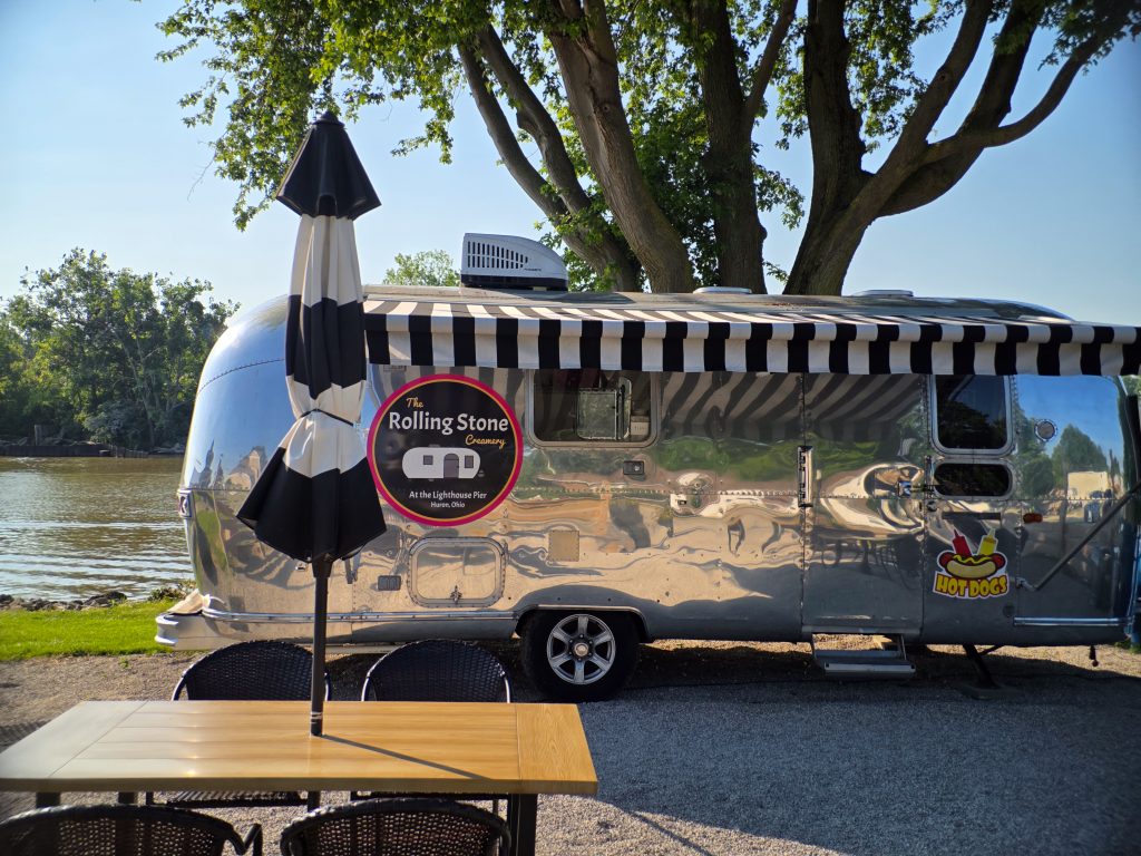 Rolling Stone food truck offering hot dogs and ice cream on the Huron riverfront boardwalk.