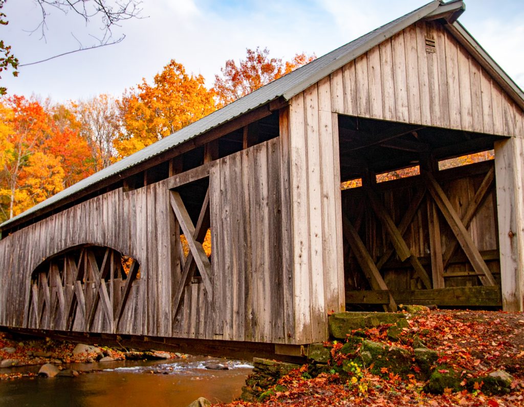Covered bridge surrounded by autumn foliage in Ashtabula County, Ohio.