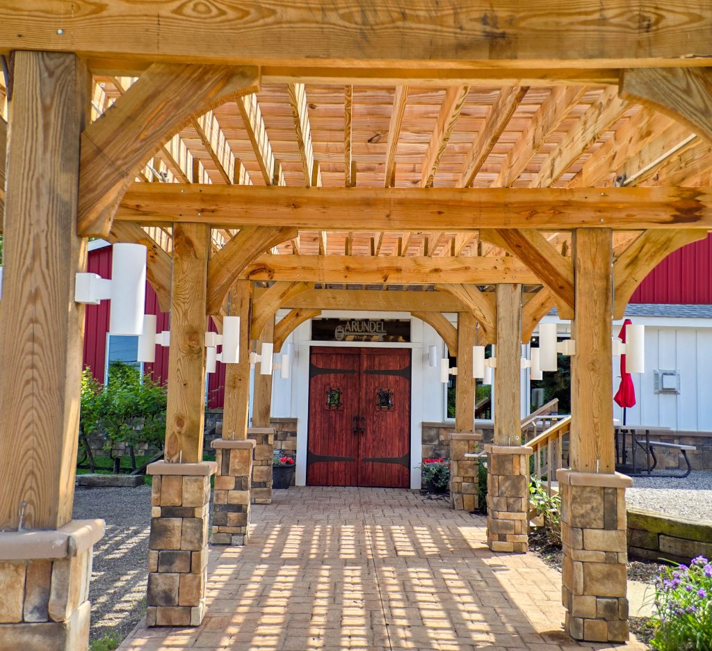 Stone and beam entrance canopy and sign for Arundel Cellars & Brewing near North East, Pennsylvania.