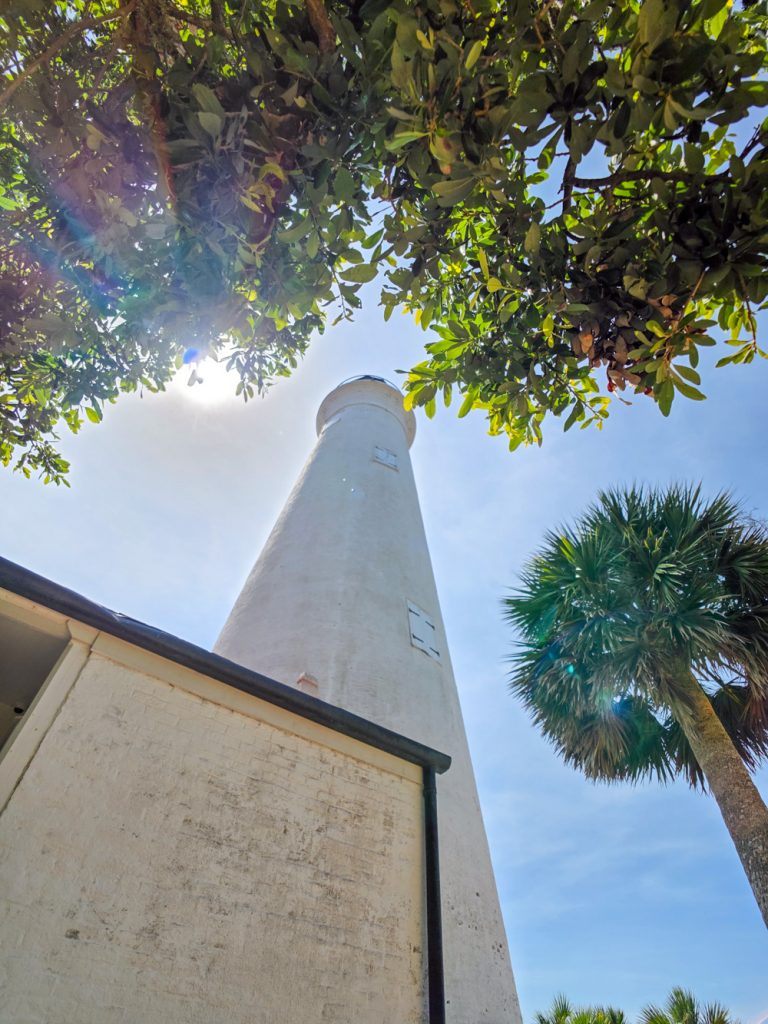 Bright sun positioned above St. Marks Lighthouse near the Gulf Coast